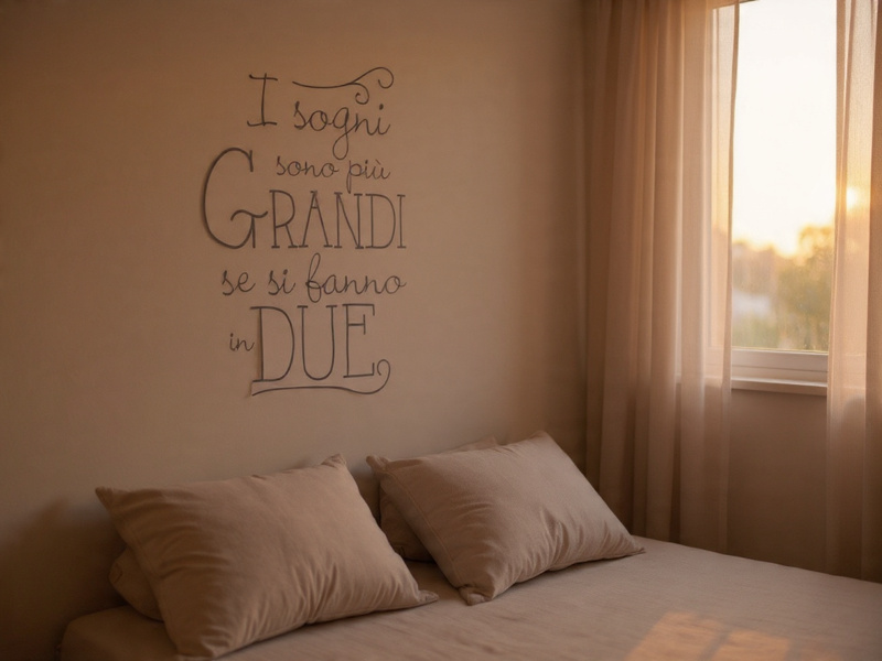 Sticker adesivo con frase “I sogni sono più grandi se si fanno in due” applicato sopra la testata del letto in camera da letto luminosa
